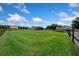 Lush green backyard with a barn, shed, and well-maintained lawn surrounding the charming single-Gathering home at 14130 Sw 8Th Ave, Ocala, FL 34473