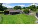 Exterior view of horse stables, well-maintained grassy field and split rail fence at 14130 Sw 8Th Ave, Ocala, FL 34473