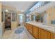This bathroom features a dual sink vanity, linen closet, and tiled walk-in shower at 14130 Sw 8Th Ave, Ocala, FL 34473