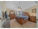 Main bedroom with wooden furniture and ceiling fan at 14130 Sw 8Th Ave, Ocala, FL 34473