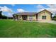 Close-up of a home with stone accents, a metal roof, and a vibrant green lawn at 14130 Sw 8Th Ave, Ocala, FL 34473