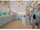 Well-lit kitchen with blue lower cabinets, stainless steel appliances, and an open layout at 14130 Sw 8Th Ave, Ocala, FL 34473