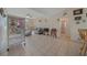 Living room features tile floors, comfy seating, and a large birdcage at 14130 Sw 8Th Ave, Ocala, FL 34473