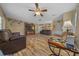 Inviting living room with wood flooring and a ceiling fan for added comfort at 14130 Sw 8Th Ave, Ocala, FL 34473