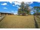 Large pasture with mature trees and wooden fencing at 14130 Sw 8Th Ave, Ocala, FL 34473