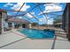 Beautiful screened-in pool area with waterfall feature, perfect for relaxation and entertaining at 14130 Sw 8Th Ave, Ocala, FL 34473