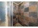 Updated shower with multi-colored stone tile and glass enclosure at 14130 Sw 8Th Ave, Ocala, FL 34473