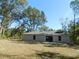 House backyard view, showcasing a large grassy area at 14268 Se 27Th Ct, Summerfield, FL 34491