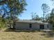 House backyard view, showcasing a large grassy area at 14268 Se 27Th Ct, Summerfield, FL 34491