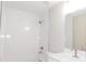 Bathroom featuring tiled shower, vanity with solid surface countertop, and modern fixtures at 14268 Se 27Th Ct, Summerfield, FL 34491