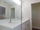Bright bathroom features double sinks, quartz countertops, and a decorative mirror at 14268 Se 27Th Ct, Summerfield, FL 34491
