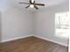 Simple bedroom with ceiling fan and wood-look floors at 14268 Se 27Th Ct, Summerfield, FL 34491