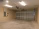 Spacious two car garage with door and opener, and overhead lighting at 14268 Se 27Th Ct, Summerfield, FL 34491