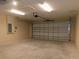 Spacious garage with overhead door and ample storage at 14268 Se 27Th Ct, Summerfield, FL 34491