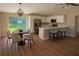 Open concept kitchen with breakfast bar, stainless steel appliances and dining area at 14268 Se 27Th Ct, Summerfield, FL 34491