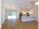Open kitchen and living area with stainless steel appliances, recessed lights, hanging light, and ample counter space at 14268 Se 27Th Ct, Summerfield, FL 34491