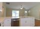 Modern kitchen with stainless steel dishwasher and white cabinets at 14268 Se 27Th Ct, Summerfield, FL 34491