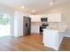 Modern kitchen featuring stainless steel appliances and white cabinets at 14268 Se 27Th Ct, Summerfield, FL 34491