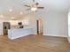 Open living room with hardwood floors and a ceiling fan at 14268 Se 27Th Ct, Summerfield, FL 34491