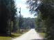 Rural road view with lush trees and mailboxes at 14268 Se 27Th Ct, Summerfield, FL 34491