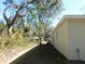 Landscaped side yard with mature trees and privacy at 14268 Se 27Th Ct, Summerfield, FL 34491