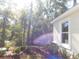 Landscaped side yard with mature trees and privacy at 14268 Se 27Th Ct, Summerfield, FL 34491