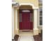 Elegant red front door entry with sidelights and arched columns at 16052 Sw 15Th Ct, Ocala, FL 34473