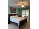 Main bedroom with king-size bed and access to backyard at 16052 Sw 15Th Ct, Ocala, FL 34473