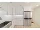 Modern kitchen with stainless steel refrigerator and white cabinets at 1728 Se 8Th St, Ocala, FL 34471