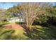 Brick patio in the backyard, partially shaded by a tree, offering a relaxing outdoor space at 1728 Se 8Th St, Ocala, FL 34471