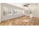 Sunroom with terracotta tile flooring and numerous windows at 1728 Se 8Th St, Ocala, FL 34471