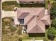 Aerial view of a house with brown roof and landscaped yard at 17370 Se 76Th Flintlock Ter, The Villages, FL 32162