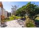 Backyard with patio and lush landscaping at 17370 Se 76Th Flintlock Ter, The Villages, FL 32162