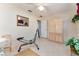 Bedroom with mirrored closet and exercise equipment at 17370 Se 76Th Flintlock Ter, The Villages, FL 32162