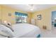 King-size bed, wicker furniture, and access to a hallway at 17370 Se 76Th Flintlock Ter, The Villages, FL 32162