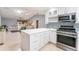 Kitchen with island overlooking living room at 17370 Se 76Th Flintlock Ter, The Villages, FL 32162