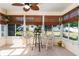 Bright sunroom with tiled floor, wicker chairs, and table at 17370 Se 76Th Flintlock Ter, The Villages, FL 32162