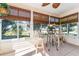 Sunroom with tiled floor, wicker chairs, and table at 17370 Se 76Th Flintlock Ter, The Villages, FL 32162