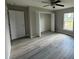 Spacious bedroom with wood-look floors and a large closet at 1776 Sw 161St Pl, Ocala, FL 34473