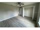 Bedroom with wood-look floors, ceiling fan, and a closet at 1776 Sw 161St Pl, Ocala, FL 34473