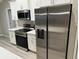 Modern kitchen features stainless steel appliances and white cabinetry at 1776 Sw 161St Pl, Ocala, FL 34473