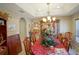 Bright dining room features a large table, beautiful chandelier, and hutch at 201 Emerald Loop Pass, Ocala, FL 34472