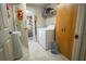 Clean, well-lit laundry room with washer, dryer, and storage cabinet at 201 Emerald Loop Pass, Ocala, FL 34472