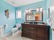 Bathroom with a light blue vanity, toilet, and shower at 20921 Sw 36Th St, Dunnellon, FL 34431