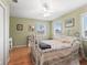 Charming bedroom with light green walls and a white metal bed frame at 20921 Sw 36Th St, Dunnellon, FL 34431