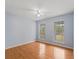 Light-filled bedroom with hardwood floors and two large windows at 20921 Sw 36Th St, Dunnellon, FL 34431