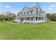 Two-story home exterior with wrap-around porch at 20921 Sw 36Th St, Dunnellon, FL 34431