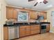 Kitchen boasts stainless steel appliances and wood cabinets at 20921 Sw 36Th St, Dunnellon, FL 34431