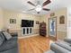 Living room with hardwood floors and a large flat-screen TV at 20921 Sw 36Th St, Dunnellon, FL 34431