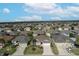 Aerial view of a residential neighborhood with houses and palm trees at 2304 Grenadier Way, The Villages, FL 32162